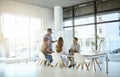 Group of diverse businesspeople having a meeting in an office at work. Young african american businessman talking while Royalty Free Stock Photo