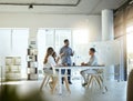 Group of diverse businesspeople having a meeting in an office at work. Young african american businessman talking while Royalty Free Stock Photo