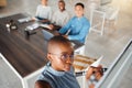 Group of diverse businesspeople having a meeting in an office at work. Young african american businesswoman writing an Royalty Free Stock Photo