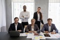 Group of diverse businesspeople posing in office for corporate picture Royalty Free Stock Photo