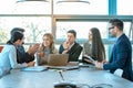 Group of diverse executives having brainstorming business meeting at conference table in office. Royalty Free Stock Photo