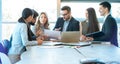 Group of diverse executives having brainstorming business meeting, discussing and reviewing paperwork at table in office Royalty Free Stock Photo