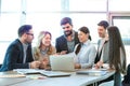 Group of diverse executives having brainstorming business meeting, discussing and reviewing paperwork at office. Royalty Free Stock Photo