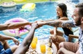 Group of diverse friends enjoying summer time by the pool Royalty Free Stock Photo