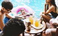 Group of diverse friends enjoying summer time by the pool Royalty Free Stock Photo