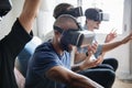 Group of diverse friends experiencing virtual reality with VR hea