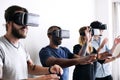 Group of diverse friends experiencing virtual reality with VR headset Royalty Free Stock Photo