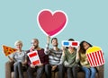 Group of diverse friends holding movie emoticons