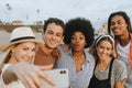 Group of diverse friends taking a selfie at the beach Royalty Free Stock Photo