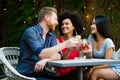 Group of diverse friends talking and having fun at cafe outdoor Royalty Free Stock Photo