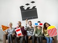 Group of diverse friends watching movie together Royalty Free Stock Photo