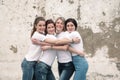 Group of diverse girls in tshirts and jeans over street wall Royalty Free Stock Photo