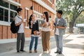 Group of diverse happy Asian college students are enjoying talking after classes on a footpath Royalty Free Stock Photo