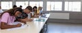 Group of diverse high school students having test exam at classroom.