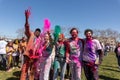 several people celebrating the festival with colored powder on their hands