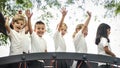 Group of diverse kindergarten students with arms raised Royalty Free Stock Photo