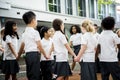 Group of diverse kindergarten students standing holding hands to Royalty Free Stock Photo