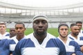 Group of diverse male rugby players standing together in stadium