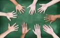 Group of Diverse Multiethnic Hands on a Blackboard Royalty Free Stock Photo