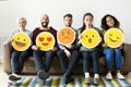 Group of diverse people holding emoticon icons Royalty Free Stock Photo