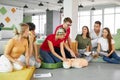 Group of diverse people practice first aid training by hand