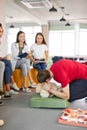 Group of diverse people practice first aid training by hand Royalty Free Stock Photo