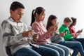 Group Of Diverse Preteen Children Using Smartphones Over Gray Background Royalty Free Stock Photo