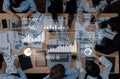 Group of Diverse Professionals Engaged in Detailed Data Analysis Meeting with Graphs and Charts Displayed on Digital Royalty Free Stock Photo