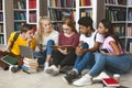 Group of diverse students sitting on floor at library Royalty Free Stock Photo