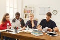 Group of diverse students studying at wooden table Royalty Free Stock Photo