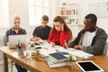 Group of diverse students studying at wooden table Royalty Free Stock Photo