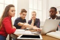 Group of diverse students studying at wooden table Royalty Free Stock Photo