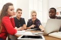 Group of diverse students studying at wooden table Royalty Free Stock Photo