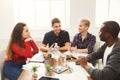 Group of diverse students studying at wooden table Royalty Free Stock Photo