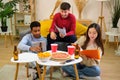 Group of diverse university colleagues studying and eating pizza together. Royalty Free Stock Photo