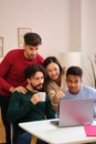 Group of diverse university colleagues studying together with a laptop. Royalty Free Stock Photo