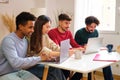 Group of diverse university colleagues studying together at shared flat. Royalty Free Stock Photo
