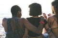 Group of diverse women sitting at the beach together Royalty Free Stock Photo