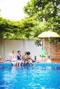 Group of diverse women sitting by the pool Royalty Free Stock Photo