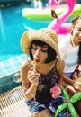 Group of diverse women sitting by the pool blow soap bubble Royalty Free Stock Photo