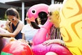 Group of diverse women sitting by the pool with inflatable tubes Royalty Free Stock Photo