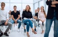 Group of diverse young people sitting in a conference room Royalty Free Stock Photo