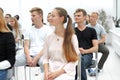 Group of diverse young people sitting in a conference room Royalty Free Stock Photo