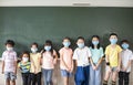 Group of diverse young students wear mask and standing together in classroom Royalty Free Stock Photo