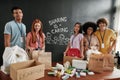 Group of diverse young volunteers smiling at camera while packing pills, medicine donation, Sharing is Caring Royalty Free Stock Photo