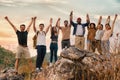 Group of diversity people having fun together climbing up rocky mountains to the peak