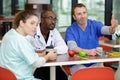 group doctors in cafeteria eating relaxing talk Royalty Free Stock Photo