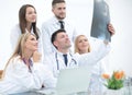 Group of doctors discussing an x-ray ,sitting at the table.