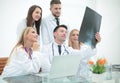 Group of doctors discussing an x-ray ,sitting at the table.