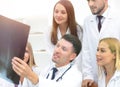 Group of doctors discussing an x-ray ,sitting at the table.